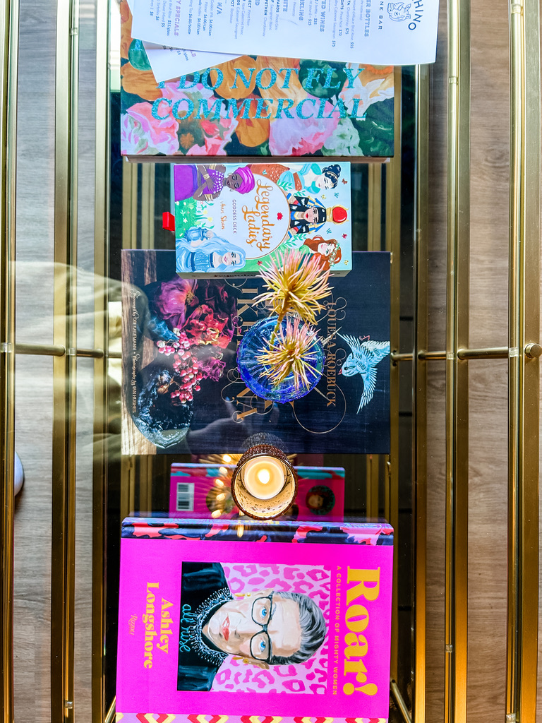 Overhead view of a styled coffee table with books and decor.