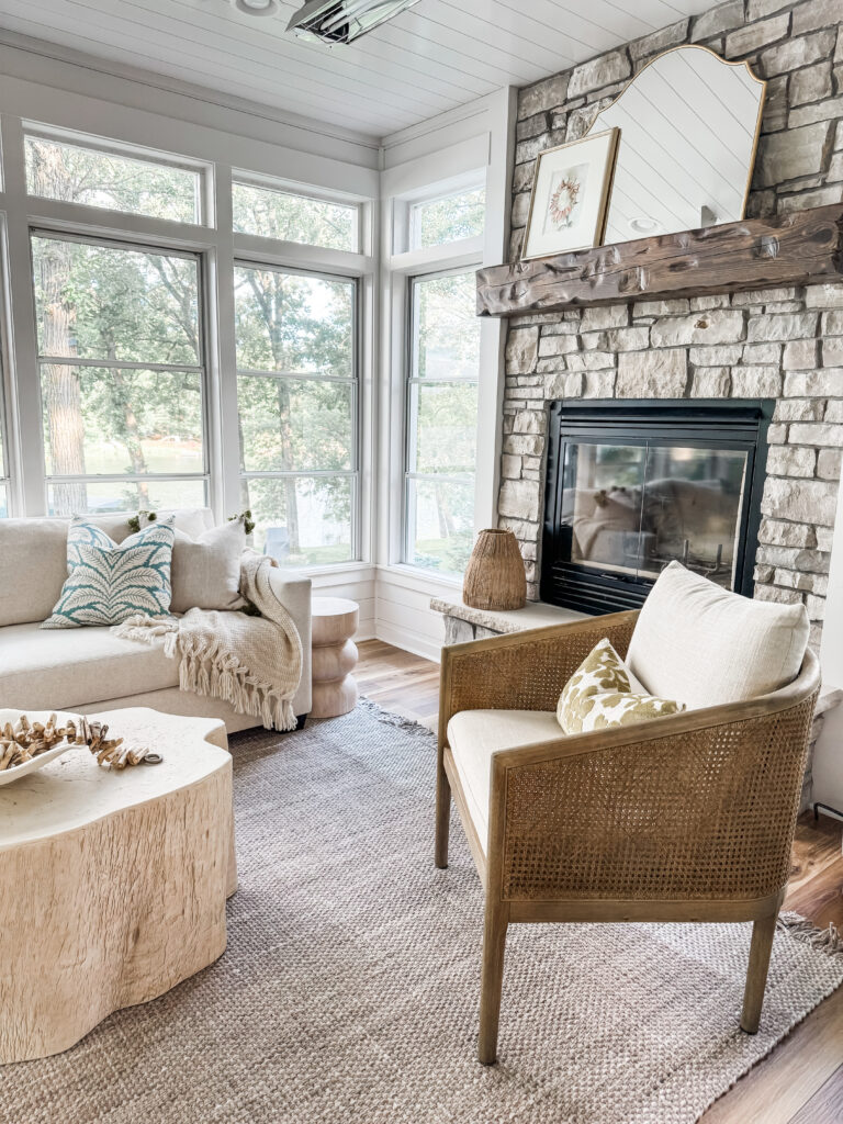 A stone fireplace with seating set around.