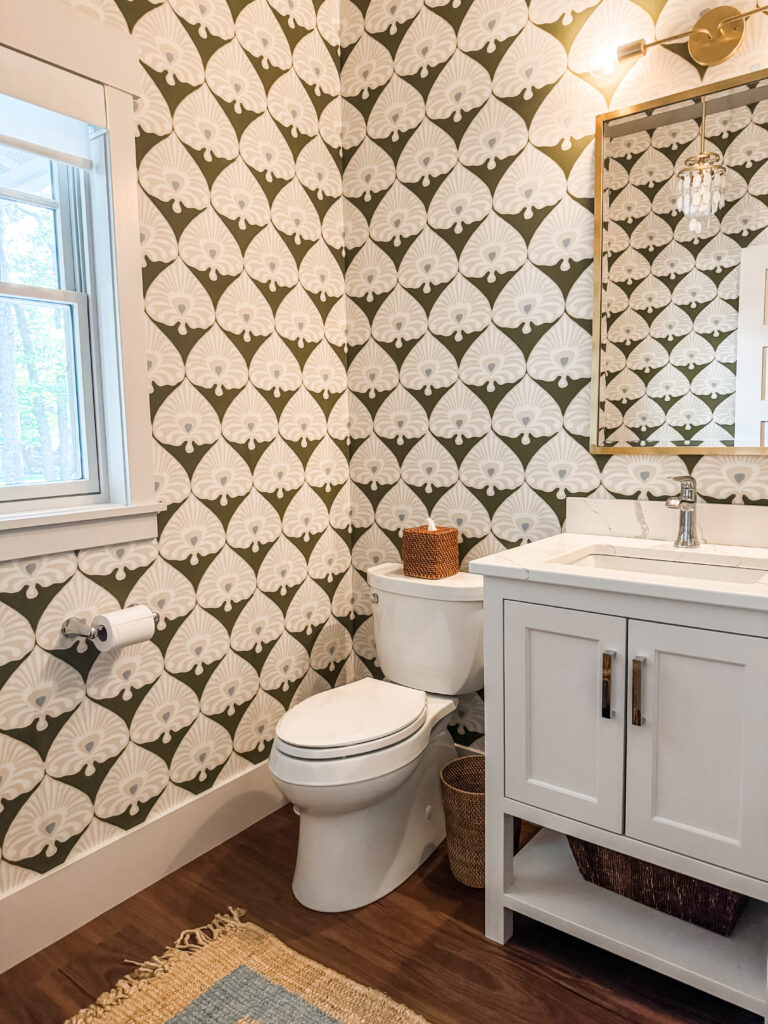A green pattern wallpaper in a powder bathroom.