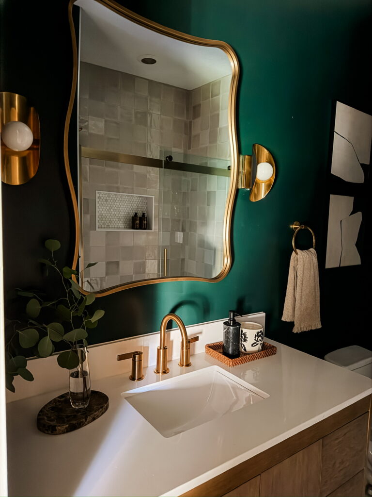 emerald green bathroom with brass hardware and fixtures
